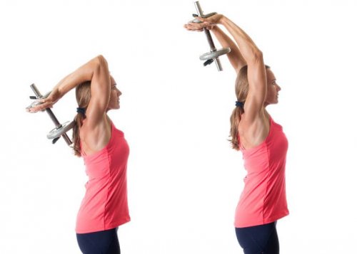 Woman lifting one dumbbell with both arms behind head