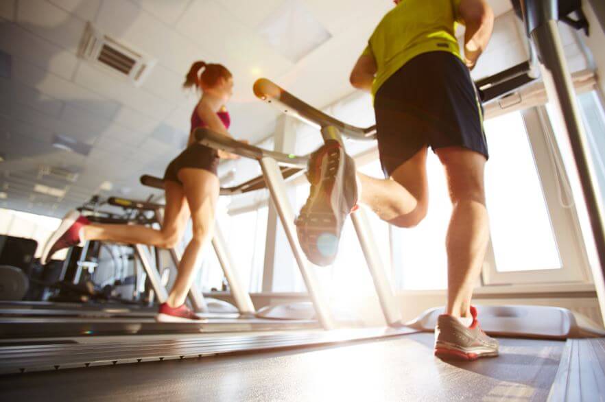 Couple running on treadmill