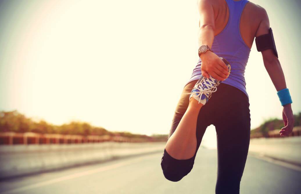 Woman stretching to prevent jumper's knee