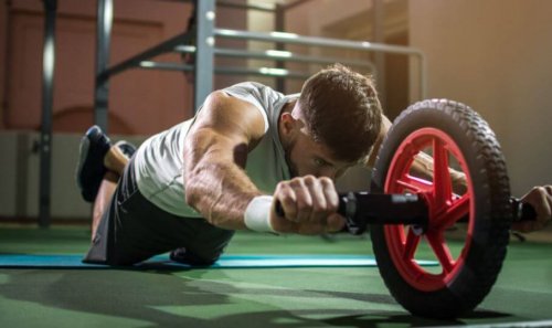 Man using ab roller at home in his gym