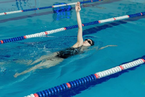 Woman in pool doing the back stroke all about swimming