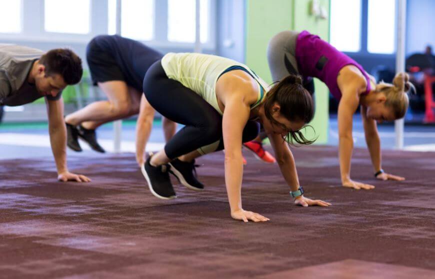 Exercising with burpees.