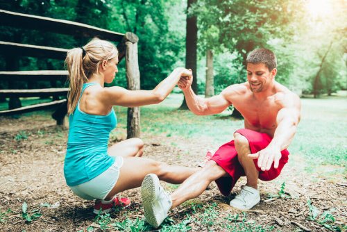Woman and man doing squats outside working out with your partner