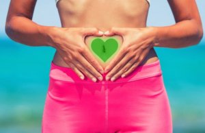 Woman with a heart over her belly to simbolize the care for her gut flora