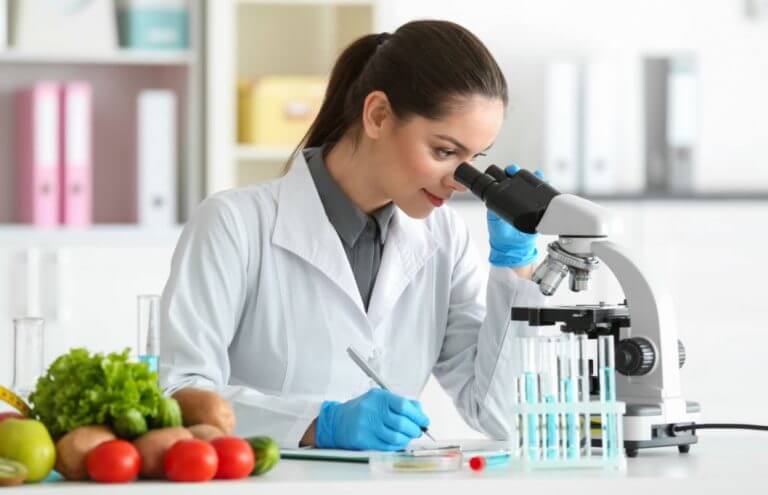 Scientist lookign at a DNA sample to learn about genetics and their role in training and supplementation