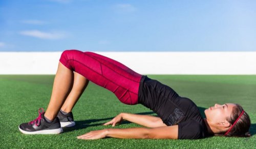 Woman doing bridge pose outside
