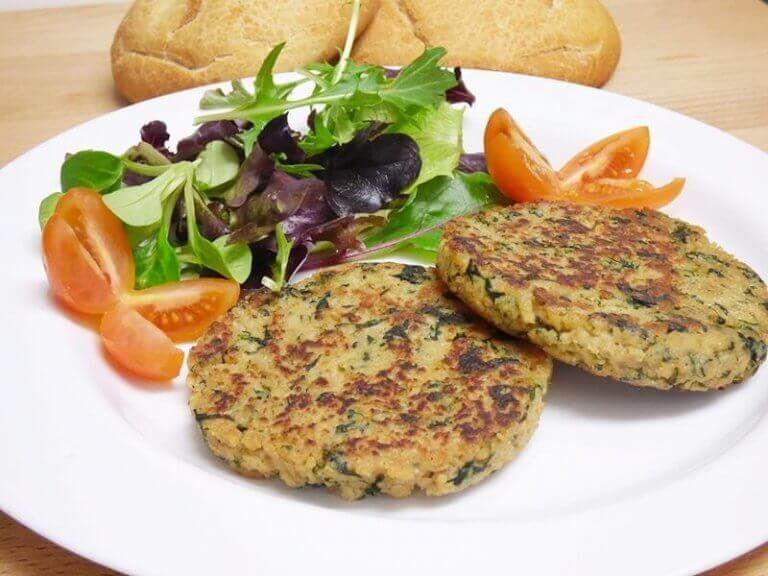 Textured soy vegetarian burger patties with a green salad on the side