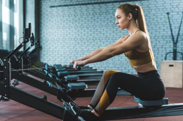 A woman using the rowing machine at the gym as part of her cardio training