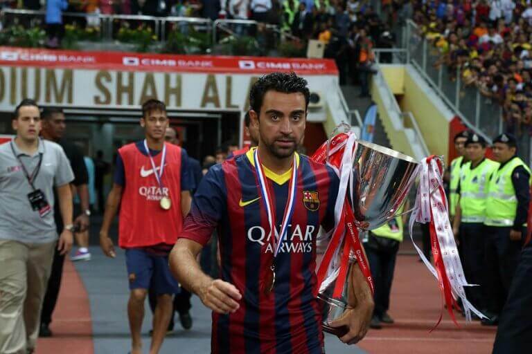 Xavi Hernández holding one of his many trophies