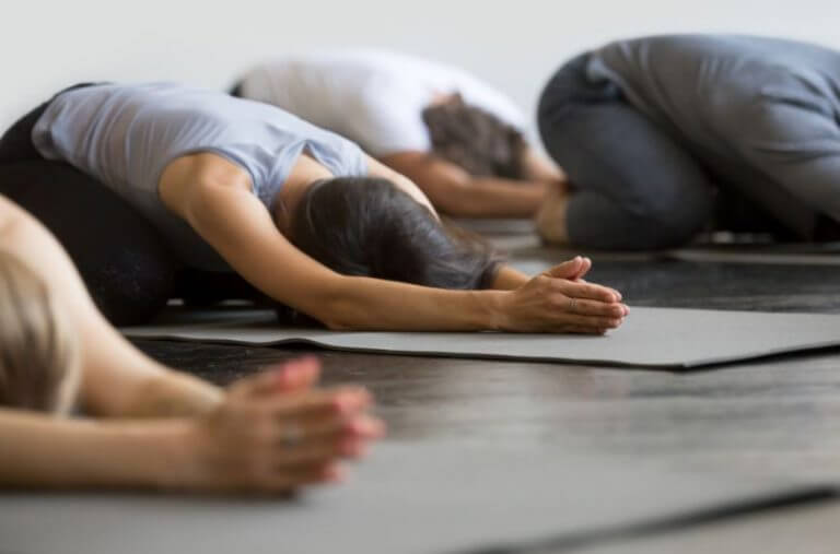 A group of people doing a yoga routine