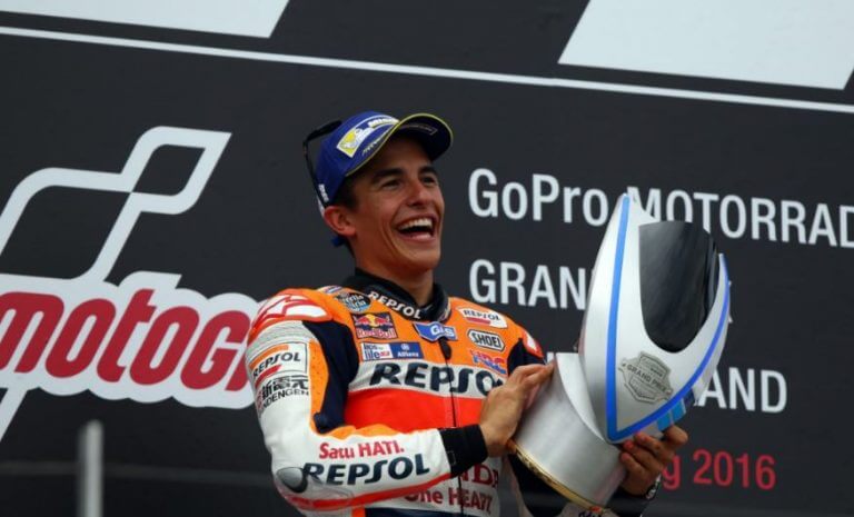 Marc Márquez holding one of his racind trophies in the Grand Prix