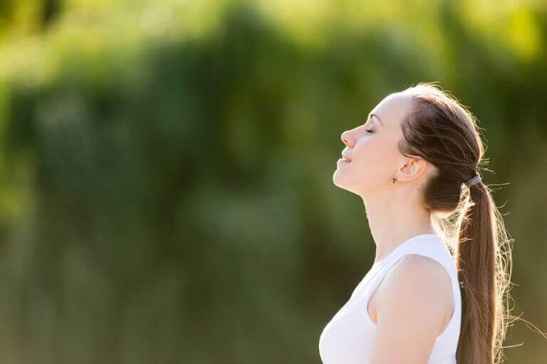 A woman doing Shakti yoga outdoors