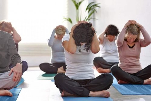 Women in yoga class doing neck stretch