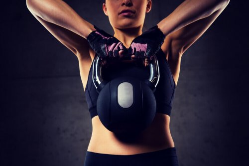 Woman lifting a Russian dumbbell at the gym