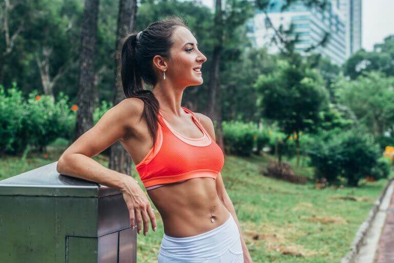 A woman relaxing by the park after her workout