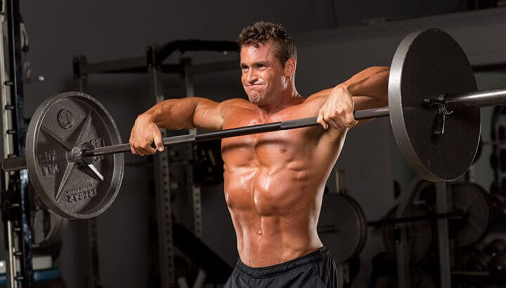 A man doing the vertical rowing movement with a bar