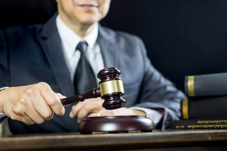 A man holding a judge hammer