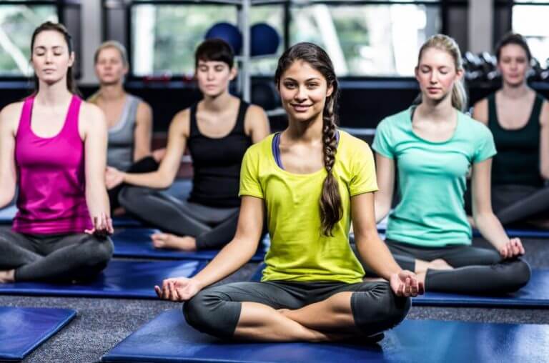 A group of people doing yoga to improve their mood