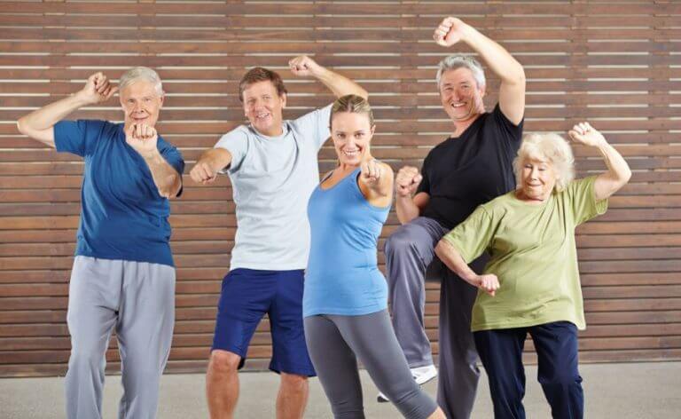 A group of old people doing zumba to slow down aging