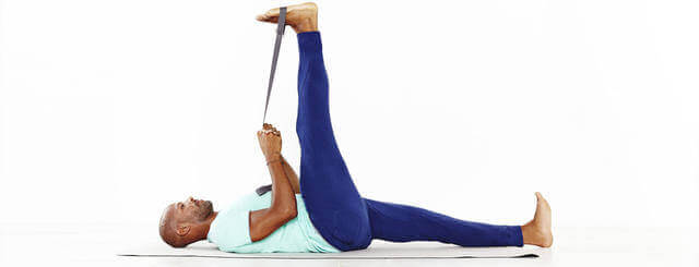 A man using resistance bands to do leg stretches