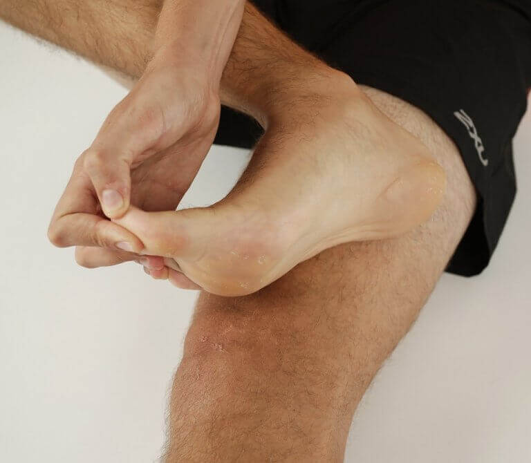 A man doing plantar fascia stretches to prevent injuries and plantar fasciitis