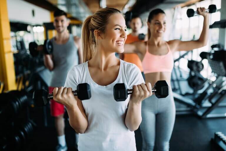 A woman training with a group of people to stay consistent with her workouts