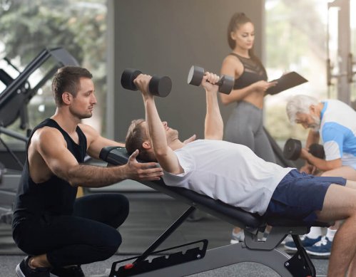 A man performing an incline dumbbell press.
