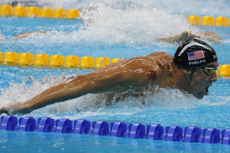 Photo of Phelps swimming in the race, which supports the text