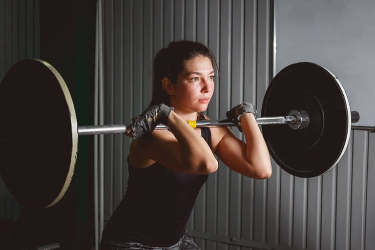 A girl lifting weights as part of her HIIT routine