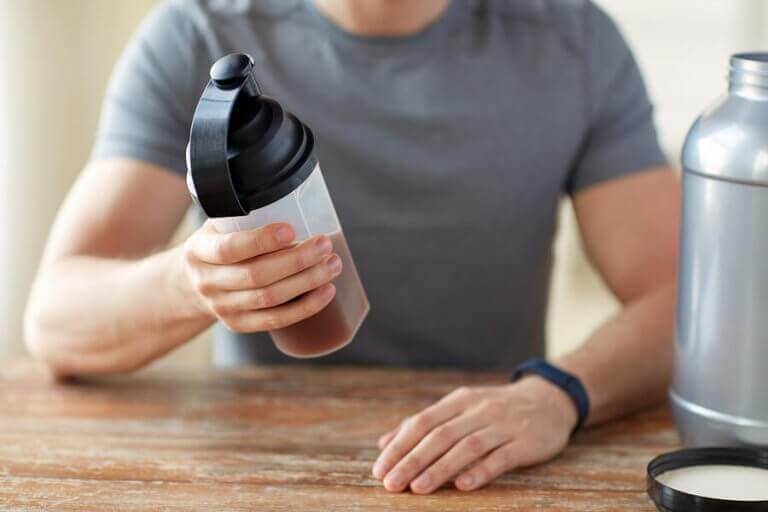 A man using a creatine shake as part of his supplementing program