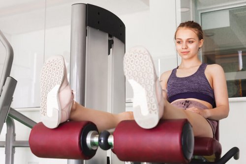 A young woman doing leg training.