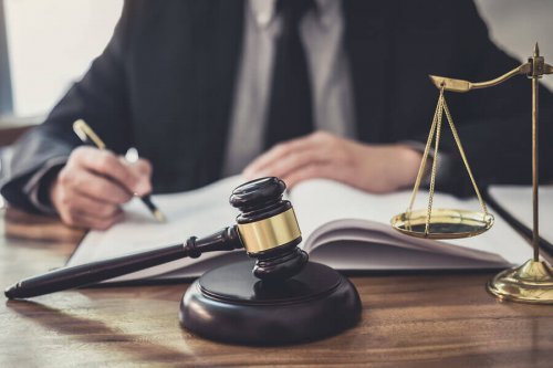 A man with a gavel in front of him.