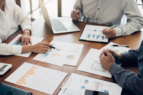 People looking at charts at a table.