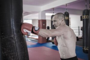 A man punching a punching bag.