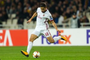 A soccer player kicking the ball.