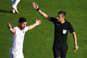 A soccer player and a referee. 