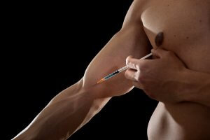 An athlete giving himself a shot.