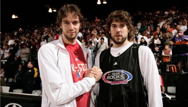 The Gasol brothers holding hands after a basketball game