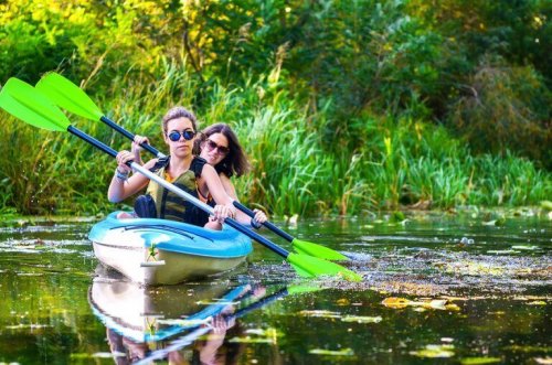Photo of two women canoeing to support text topic.