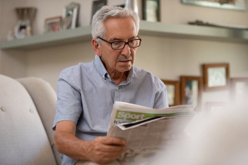 A man reading the l'equipe newspaper.