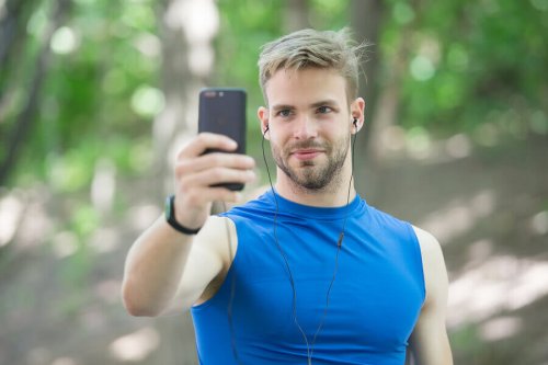 A man taking a selfie with a phone.