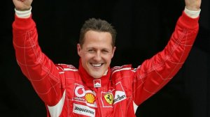 Michael Schumacher raising his arms to celebrate.