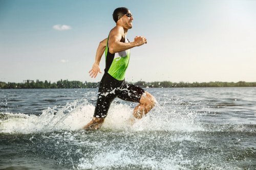 A man embodying the olympic spirit by improving his running speed.