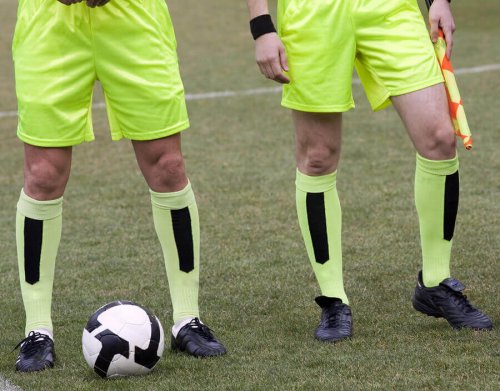 Two assistant referees with one flag.