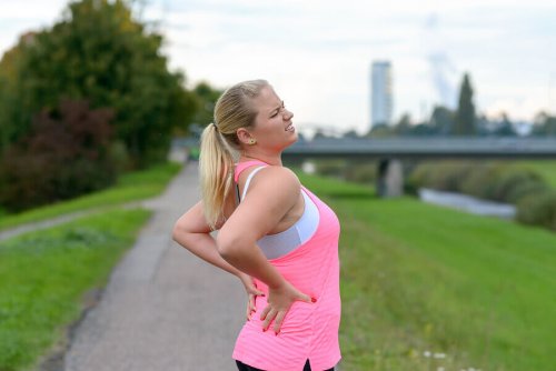 A woman outside with lower back pain.