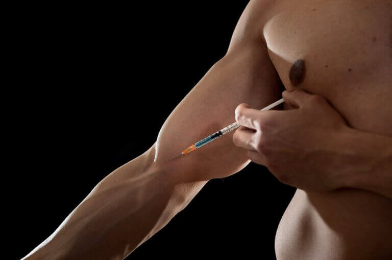 A man injecting a doping substance into his arm before a boxing match