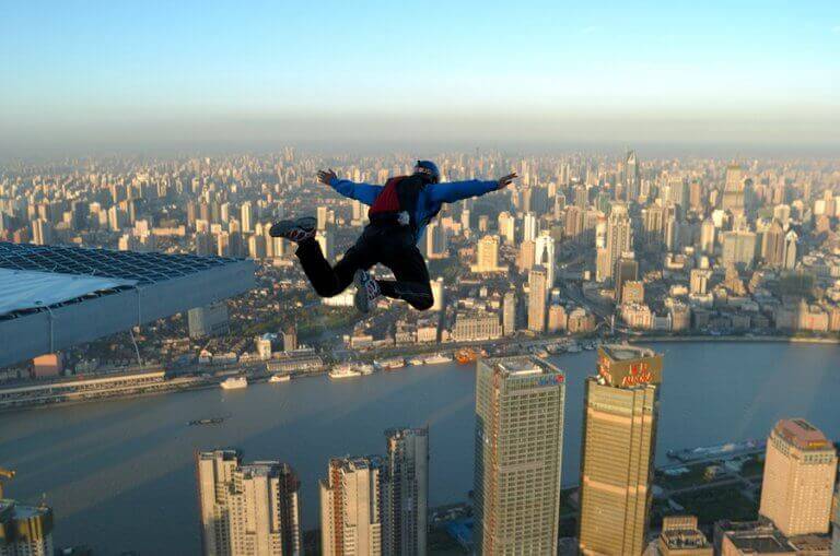 A man base jumping from a building
