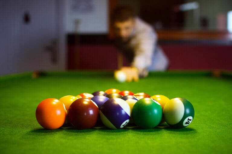 A billiard player following the competition rules during his lag shot