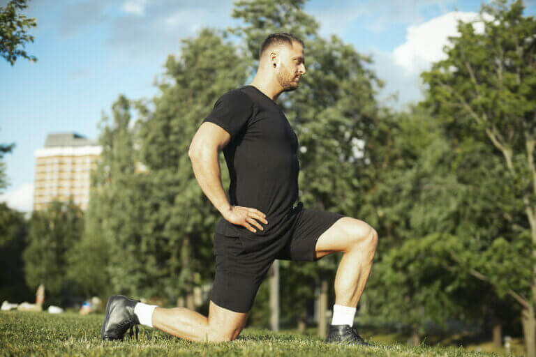A man doing lunges in a park