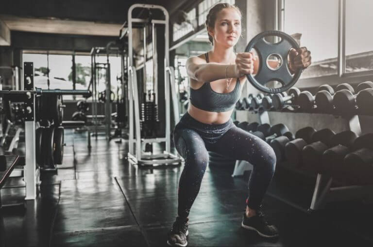 A woman lifting weights at the gym
